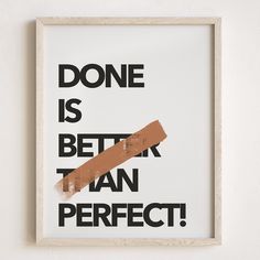 a framed poster with the words done is better than perfect in black and brown on it