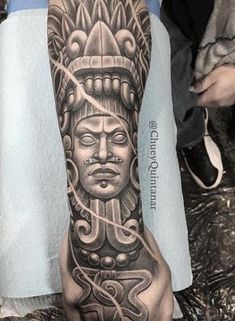 a man's arm with an intricate tattoo design on it