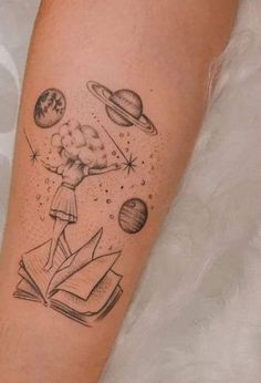 a woman with an open book and planets on her arm is shown in black ink