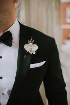 a man in a tuxedo with a flower on his lapel