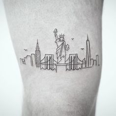 the statue of liberty tattoo is shown on the right side of the calf's leg