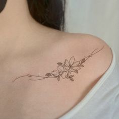 a woman with a flower tattoo on her shoulder