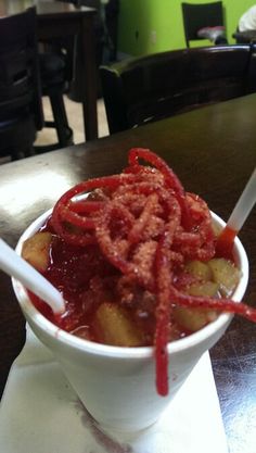 a white bowl filled with food on top of a table