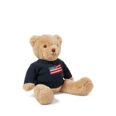 a brown teddy bear wearing a sweater with an american flag on it's chest