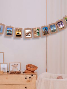 there are many pictures hanging on the clothes line in this photo frame and hemp rope