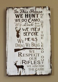 a sign on the wall that says in this house we hunt and do camo