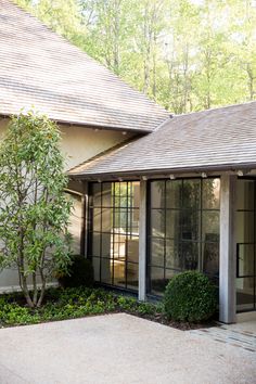 an outside view of a house with trees in the background