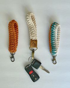 three key chains with two keys attached to them, one has a lanyard and the other has a car keychain