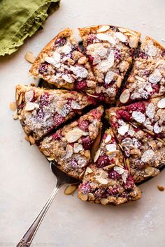 a cake with berries and almonds is cut into slices