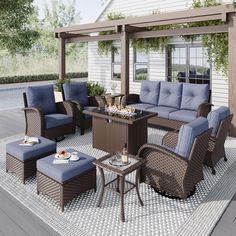 an outdoor living area with blue cushions and wicker furniture