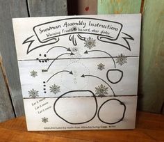 a wooden sign with snowman assembly instructions on it