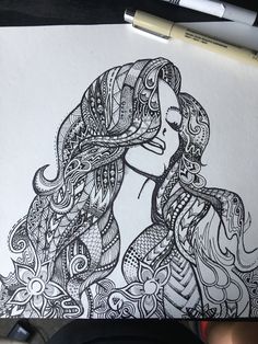 a drawing of a woman's face with long hair and intricate patterns on it