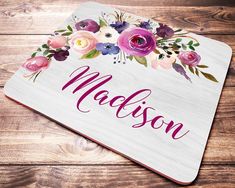 a personalized wooden coaster with flowers on it