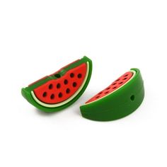 two pieces of green and red plastic with watermelon slices on the top one piece is cut in half