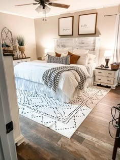 a bedroom with a bed, dressers and pictures on the wall