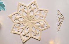 cut out paper snowflakes on a table with scissors and other crafting supplies