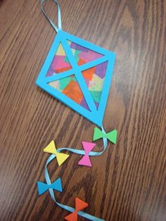 an origami kite on a wooden table