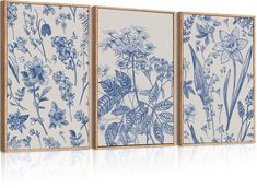 three blue and white wall art pieces with floral designs on the sides, one in wood frame