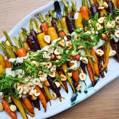 a platter filled with carrots and other vegetables