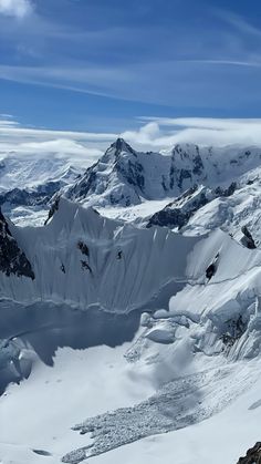 a man standing on top of a snow covered mountain