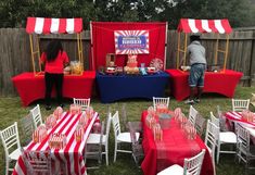 an outdoor party with red, white and blue table cloths on the tables set up