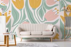 a living room scene with focus on the sofa and flower wallpaper that's painted in pastel colors