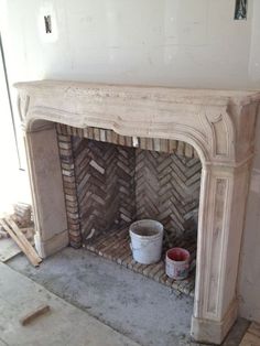 an old fireplace is being restored with new paint