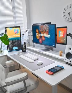 three computer monitors sitting on top of a white desk