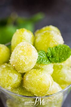 a small glass bowl filled with green powdered donuts and mint sprinkles