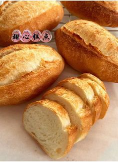 several loaves of bread sitting on top of a white counter next to each other