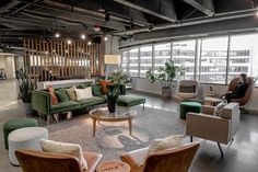 a living room filled with furniture and lots of windows