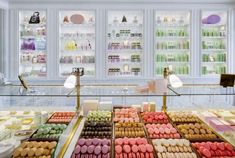 a display case filled with lots of different colored macaroons