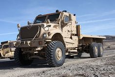 an army truck is parked in the desert