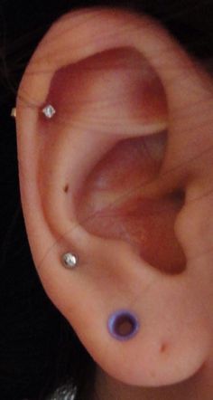 an ear with two piercings attached to it