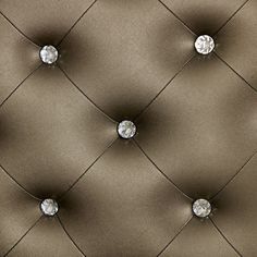 an upholstered fabric with diamond buttons on the back and sides, in brown