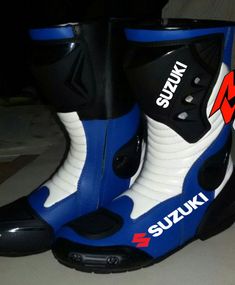 a pair of blue and white boots sitting on top of a floor next to each other