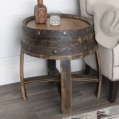 an old barrel table with a bottle on top