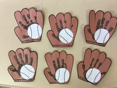 four handprinted baseball mitts are shown on the wall in this classroom setting