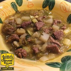 a yellow bowl filled with meat and potatoes