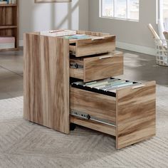 a wooden desk with three drawers in the middle and a rug on the floor next to it