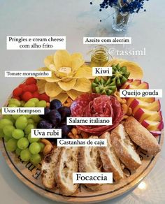 a platter filled with different types of food on top of a white tablecloth