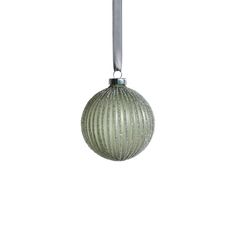 an ornament hanging from a metal bar on a white background with clippings