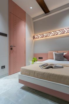 a bedroom with pink and white decor on the headboard, bed, and closet