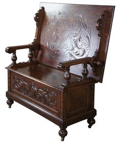 an old wooden bench with carved wood carvings on it's seat and backrest