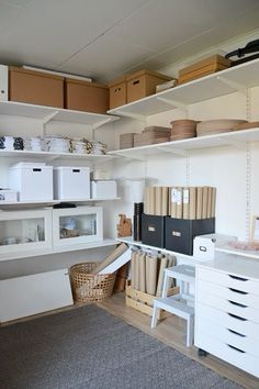 a room filled with lots of white shelves and boxes on top of eachother