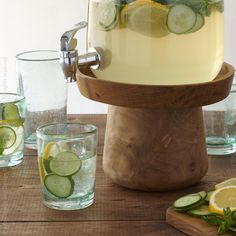 a pitcher of water with cucumbers and lemon slices