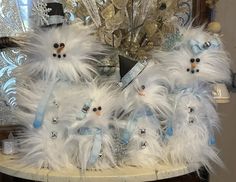 two snowmen are dressed in blue and white feathers