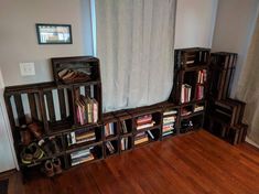 a room with wooden floors and bookshelves on the wall next to a window