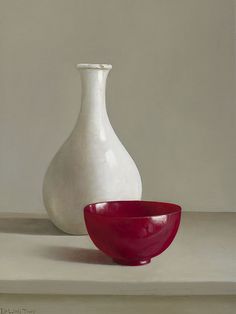 two white and red vases sitting next to each other on a counter top,