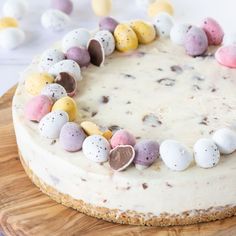 a cake with white frosting and chocolate eggs on top